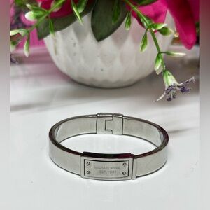 Michael Kors Silver Steel Logo-Plaque Bangle. You will look Great!